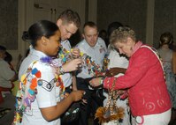Bexar County District Attorney Susan Reed presents Team Lackland members with Fiesta medals April 23 during the Texas Cavaliers River Parade at the River Walk in San Antonio. (USAF photo by Alan Boedeker)                                