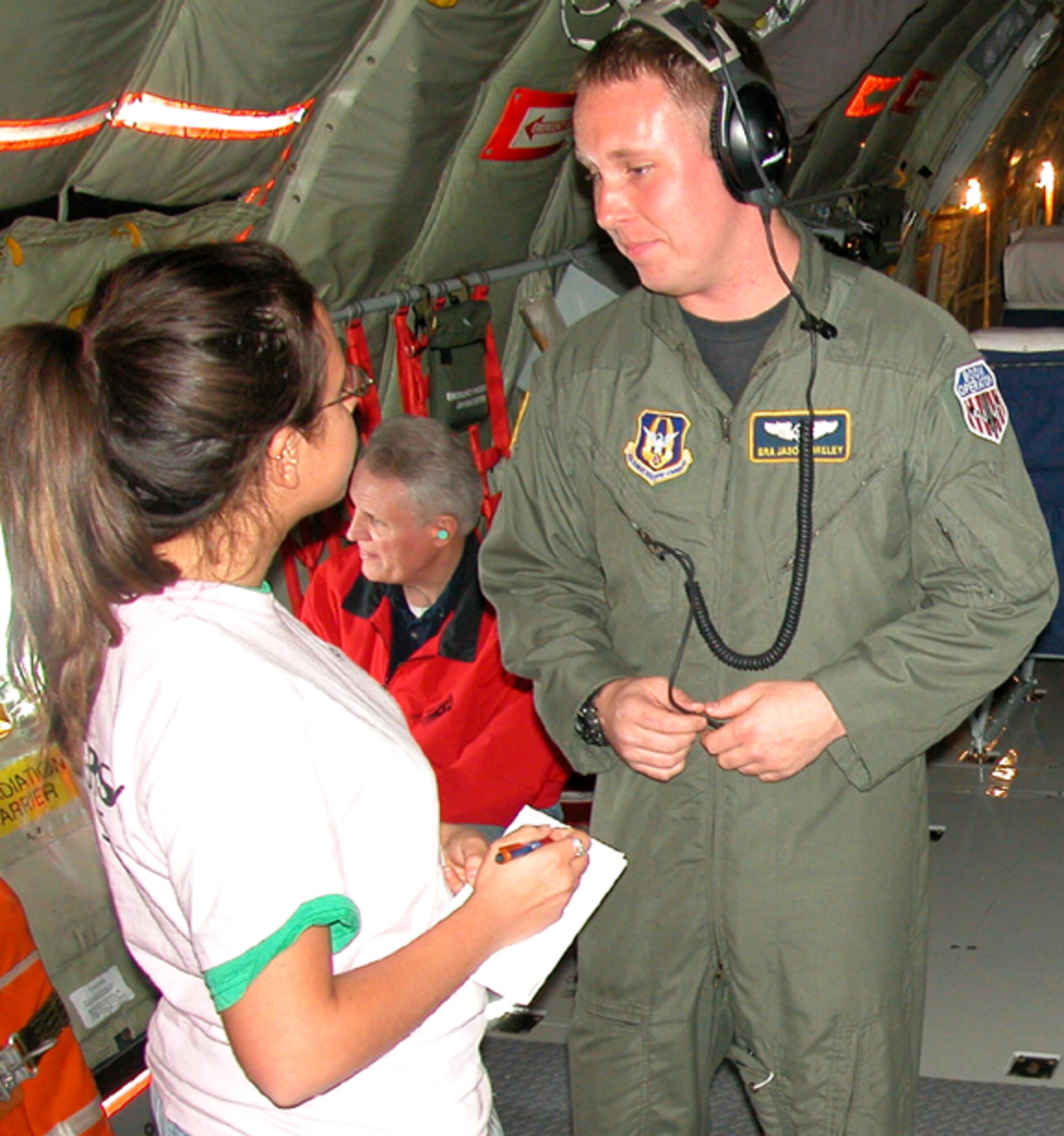 GRISSOM AIR RESERVE BASE, Ind., -- Senior Airman Jason Bireley, an inflight refueling specialist with the 72nd Air Refueing Squadron, answers questions from Katina Crow, a reporter with the Kokomo Perspective during a media flight held April 25. A total of seven members of the media had an opportunity to learn about the 434th Air Refueling Wing and the unit's mission during the event. (Air Force photo/ Senior Airman Chris Bolen)