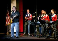 Country Music entertainer Dwayne O'Brien, from the band Little Texas, performs with Top Flight during Fiesta In Blue on April 24.  Top Flight is part of the Air Force Band of the West from Lackland AFB, Texas.  The Band of the West performs annually during Fiesta, a 10-day celebration to honor the memory of the heroes of the Alamo and the Battle of San Jacinto in 1836.  (USAF Photo by Robbin Cresswell)