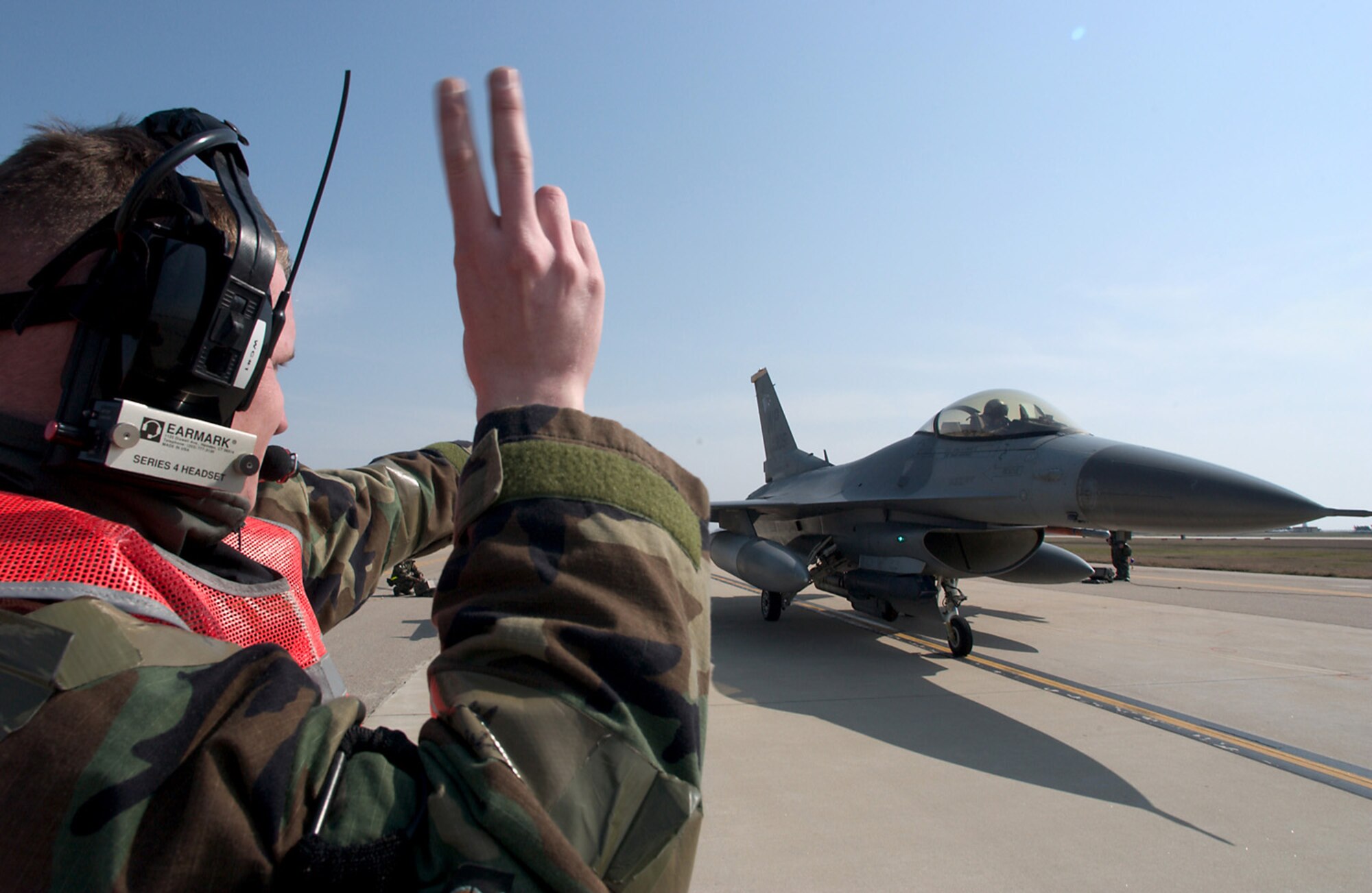 KUNSAN AB, Republic of Korea -- Senior Airman Johnathon Lavender, 8th Aircraft Maintenance Squadron, marshals an F-16 Viper on the flightline here April 19. Maintenance Airmen are the backbone of the 8th Fighter Wing?s mission, keeping the aircraft in the fight. ?The dedication of our maintenance Airmen, keeping their aircraft flying, is what enables us to claim air superiority everywhere we go,? said Col. Preston Thompson, 8th Fighter Wing vice commander and command pilot with more than 4,000 flying hours. The 8th Fighter Wing is currently undergoing an operational readiness inspection to test its ability to conduct its wartime mission. (U.S. Air Force photo by Senior Airman Barry Loo)  