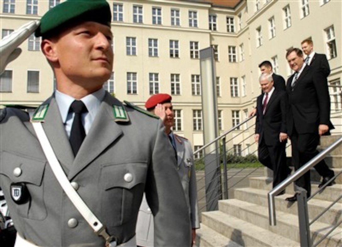 German military members salute as U.S. Defense Secretary Robert M. Gates and German Minister of Defense Franz Josef Jung exit the Ministry of Defense in Berlin, April 25, 2007. 