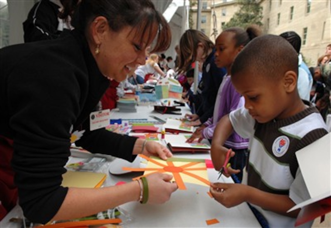 Youngsters glue and create papercrafts at America Supports You booths during the “National Take Our Daughters and Sons to Work Day” at the Pentagon, Arlington, Va., April 26, 2007.