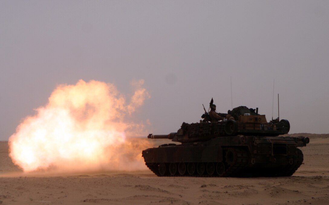 A M-1A1 Abrams Main Battle Tank from Tank Platoon, Battalion Landing Team 2/2, 26th Marine Expeditionary Unit, spits fire as it sends a 120mm shell booming down range during live-fire training at Udairi Range, Kuwait, April 27, 2007.  During the training, Tank Plt. fired 120mm main gun rounds, shot an enhanced marksmanship program course of fire and worked on pistol marksmanship.   (Official USMC photo by Cpl. Jeremy Ross) (Released)