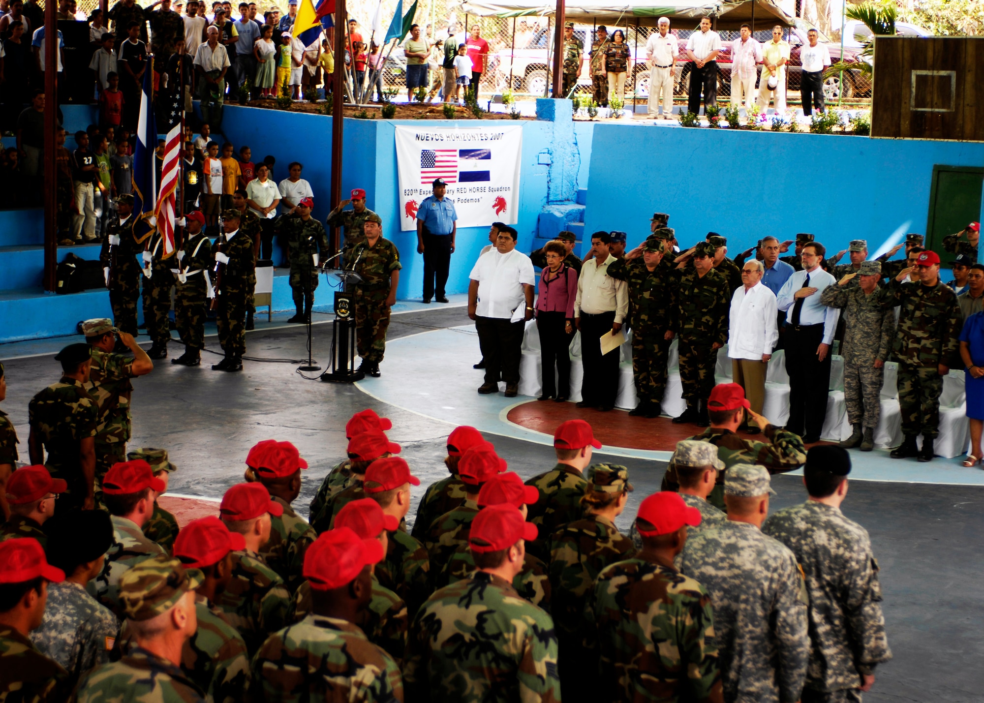 New Horizons - Nicaragua 2007 closing ceremony attendants render courtesies to the United States and Nicaraguan flags April 27. The ceremony concluded the $7.5 million joint humanitarian and training exercise, during which 250 Airmen, Soldiers and Marines built a three-room school and a five-room medical clinic and treated more than 20,000 Nicaraguan medical patients. (U.S. Air Force photo/Staff Sgt. Jason Bailey)