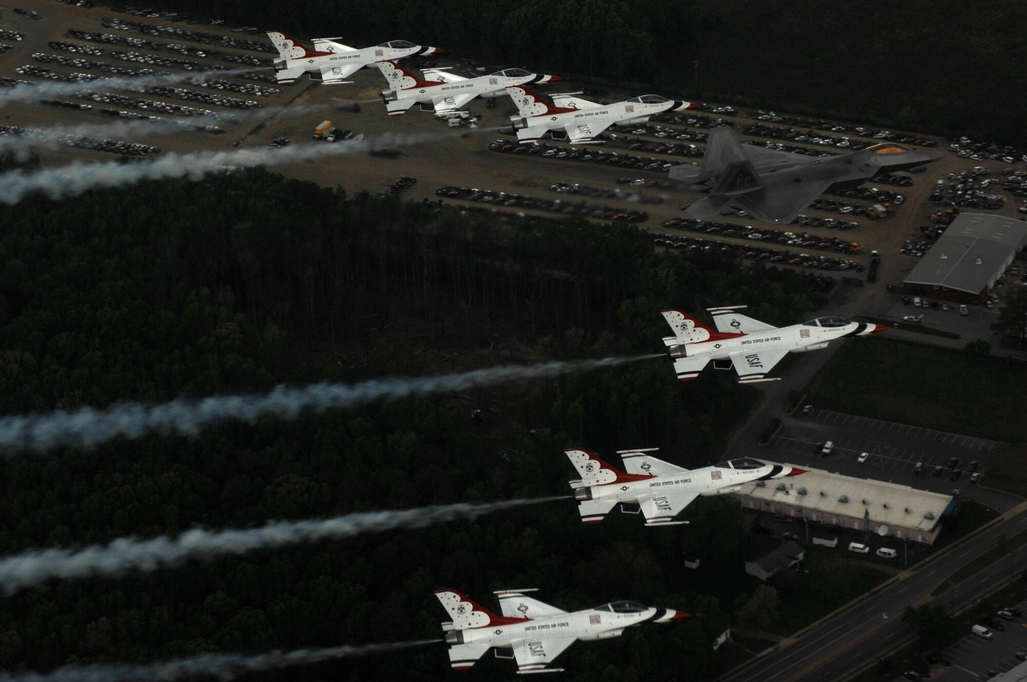 LANGLEY AIR FORCE BASE, Va. -- Maj. Max Moga, F-22A Raptor demonstration pilot, leads six Thunderbird F-16Cs in formation over Langley during their afternoon practice April 27 for the Airpower Over Hampton Roads air show scheduled for April 27 to 29. This year, the Thunderbirds and F-22 demonstrations commemorate the 60th anniversary of the U.S. Air Force. (U.S. Air  Force photo/Tech. Sgt. Justin D. Pyle)