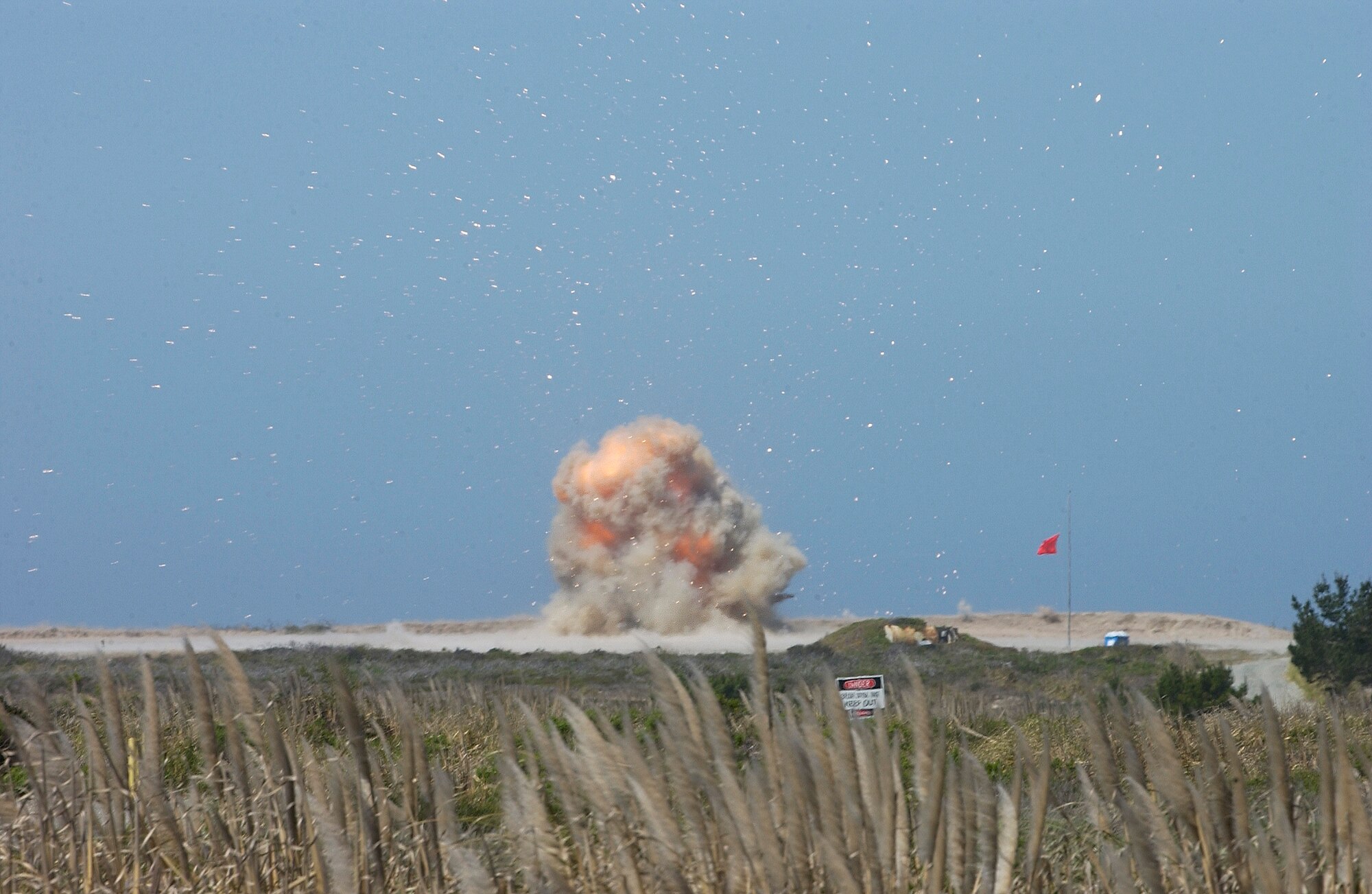 Hot shrapnel flies hundreds of feet in the air when the Vandenberg’s Explosive Ordnance Disposal team detonated an equivalent of 400 pounds of explosives April 26. Viewers stayed safe 3,000 feet from the explosion and the hazardous flying shrapnel, composed of propellant and hot metal fragments. (Photo by Airman 1st Class Ashley Tyler)