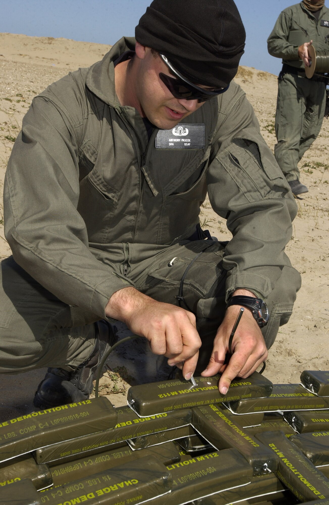 Connecting 250 pounds of C-4 together, Senior Airman Anthony Pascoe prepares for a large explosive operation at Vandenberg April 26.  Explosive Ordnance Disposal, a unit of the 30th Civil Engineer Squadron, disposed of explosive Titan II and Titan IV rocket components.
