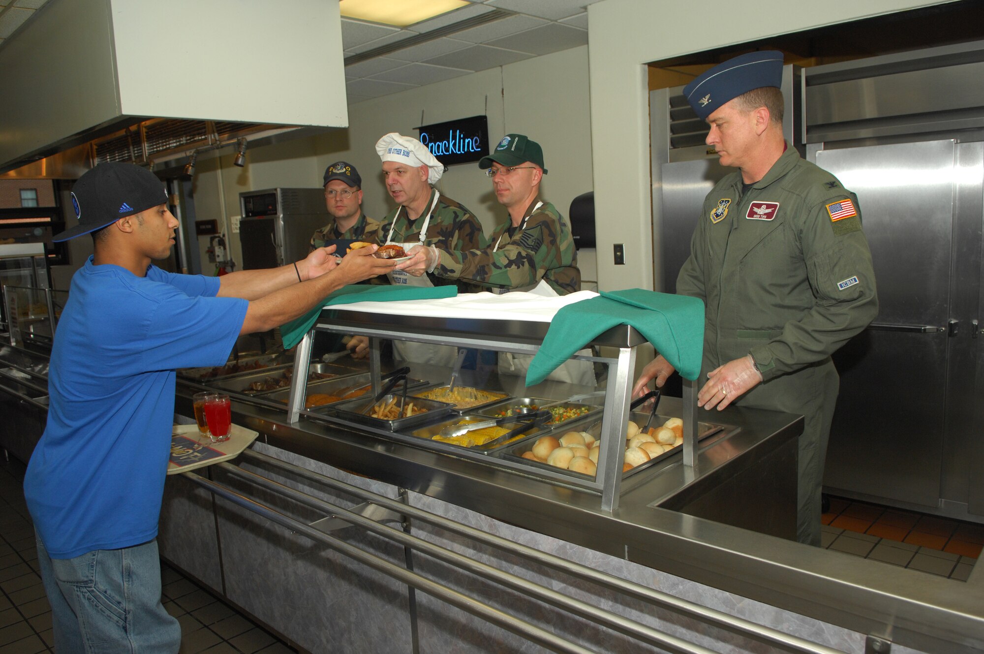 Minot Air Force Base leadership and other volunteers serve dinner to Airmen during an Airmen Appreciation Meal at the Dakota Inn Dining Facility April 26. Special meals are served to Airmen here each quarter and various holidays and observances to recognize their dedication and contributions to the U.S. Air Force. (U.S. Air Force photo by Airman 1st Class Sharida Bishop)