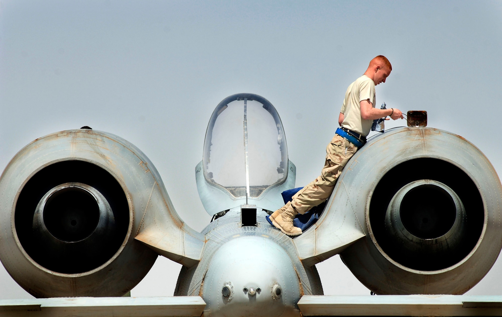 Senior Airman Kevin Crawford performs an intake and exhaust inspection on an A-10 Thunderbolt II April 25 at Al Asad Air Base, Iraq. A-10s provide close-air support to ground troops in Iraq. The 438th Air Expeditionary Group A-10s perform approximately 10 sorties daily. Airman Crawford is assigned to the 438th AEG. His hometown is Boling Brook, Ill. (U.S. Air Force photo/Tech. Sgt. Cecilio M. Ricardo Jr.) 