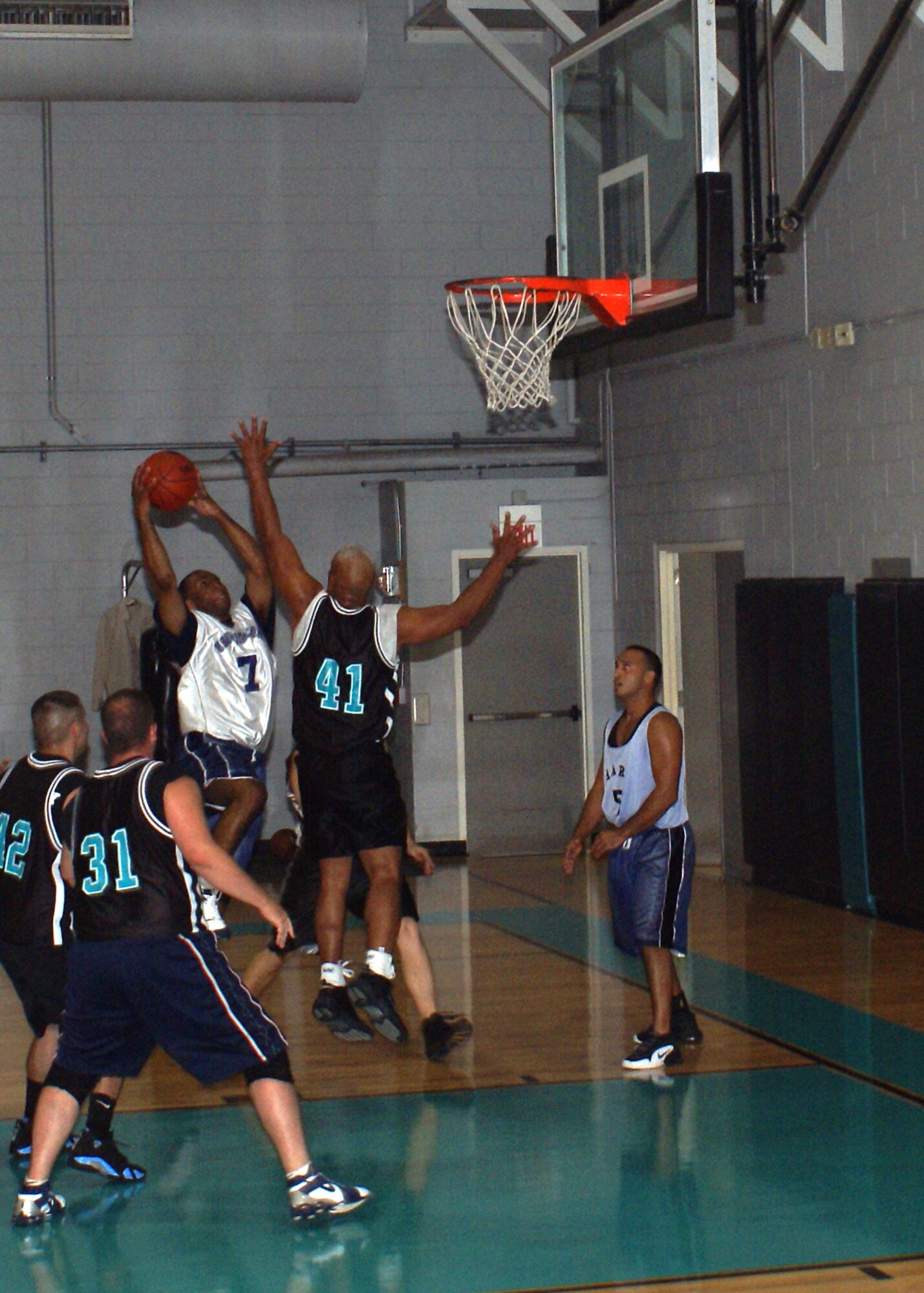 David “DC” Campbell, a forward for the Southern Command B team, drives to the basket during a recent basketball game as Manny Bobadilla of the Homestead Air Reserve Base Security Forces team challenges his shot.  
Southern Command is represented by two teams in the Homestead’s intramural basketball league, and both teams finished the regular season with a record of five wins and one loss.  The playoffs begin the week of April 30 with the teams from Southern Command ranked as the top two seeds out of seven teams. (U.S. Air Force photo/Jake Shaw)
