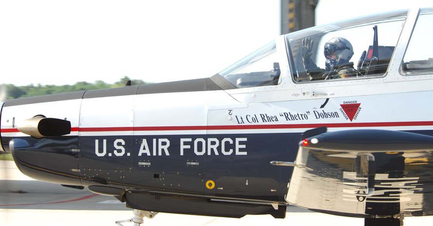 Moody Air Force Base, Ga. -- Lt. Col. Rhea Dobson, Commander of the 3rd Flying Training Squadron, waves bye to friends, family and co-workers as he prepares to fly the last T-6 out of Moody's airfield April 25.  As part of the 479th Flying Training Group, the 3rd FTS mission of training pilots is being relocated to various other bases across the Air Force. (U. S. Air Force photo by Senior Airman Angelita Lawrence)

