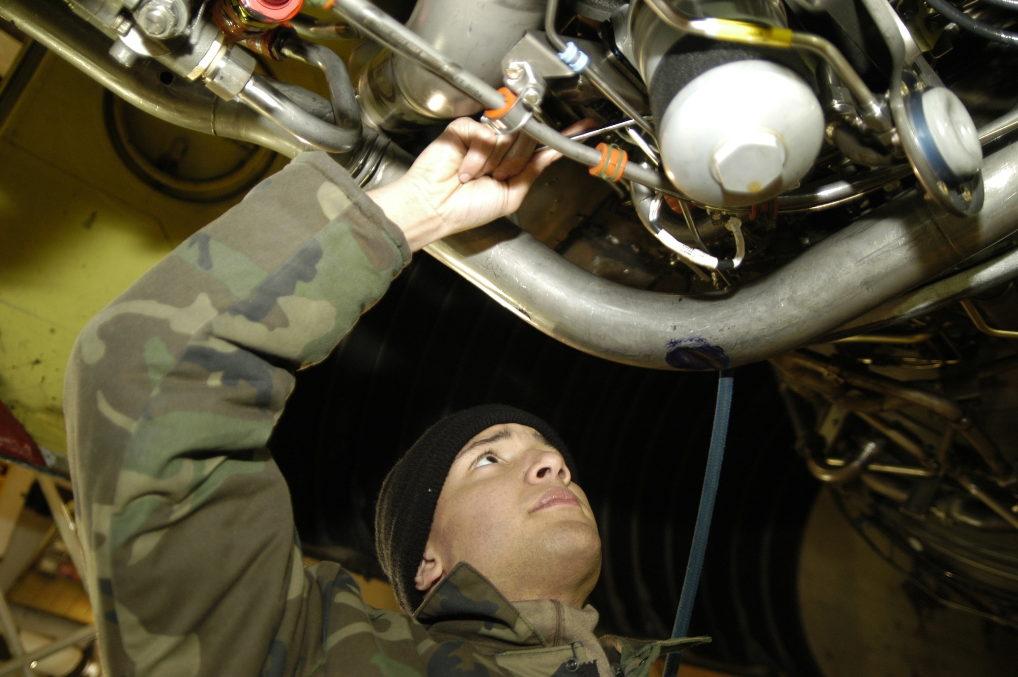 DOVER AIR FORCE BASE, Del. -- Senior Airman Matthew Mendes, 436th Maintenance Squadron Test Cell journeyman, tightens a bolt on a TF-39 engine. (U.S. Air Force photo/Senior Airman James Bolinger)                                