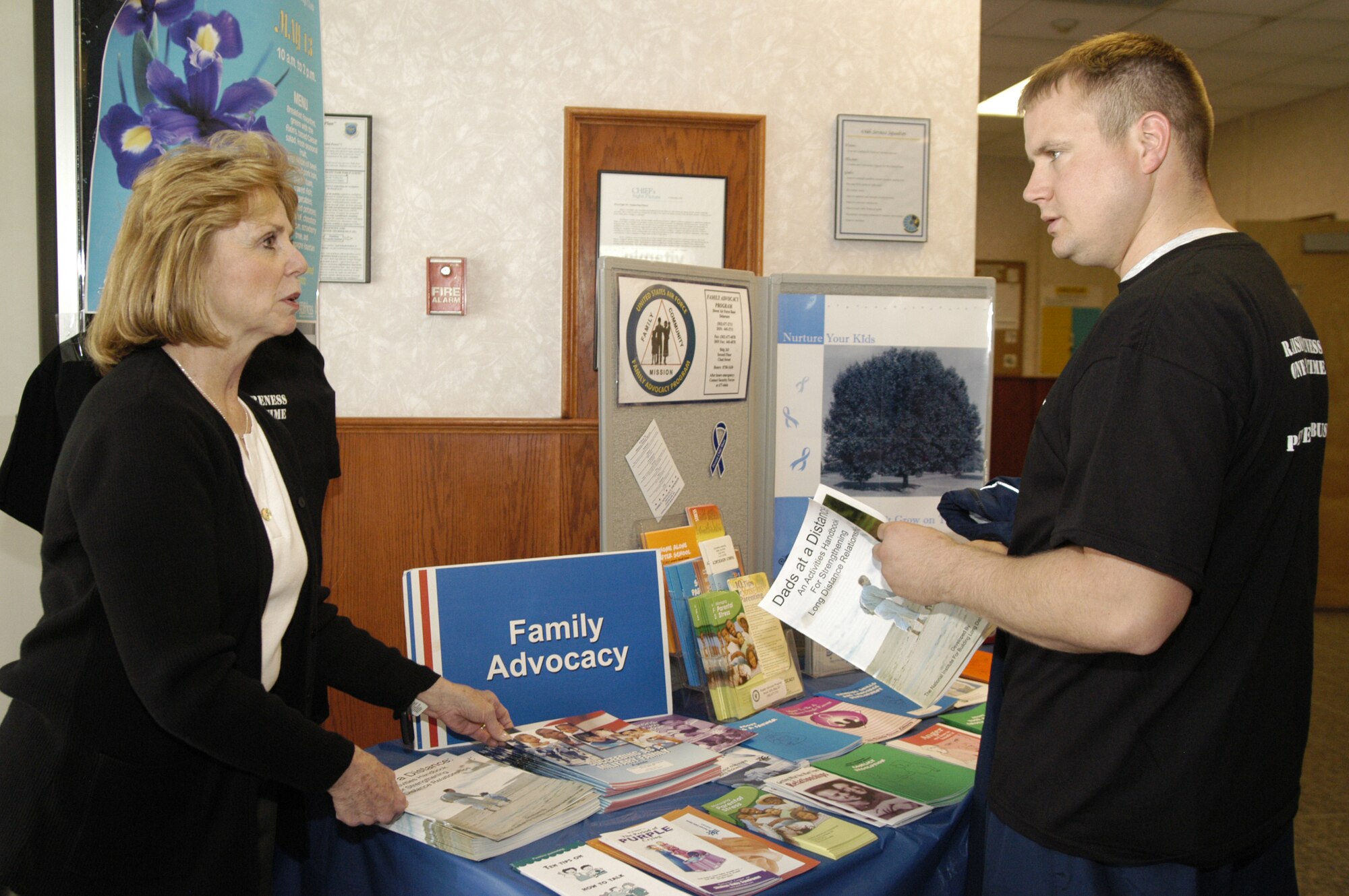 DOVER AIR FORCE BASE, Del. -- Mary Simon, 436th Medical Operations Squadron, speaks with Staff Sgt. Andrew Bishop, 436th Logistics Readiness Squadron, at the Fitness Center April 17. Mrs. Simon handed out t-shirts and information pamphlets in support of Child Abuse Prevention Month. (U.S. Air Force photo/Airman Shen-Chia Chu)