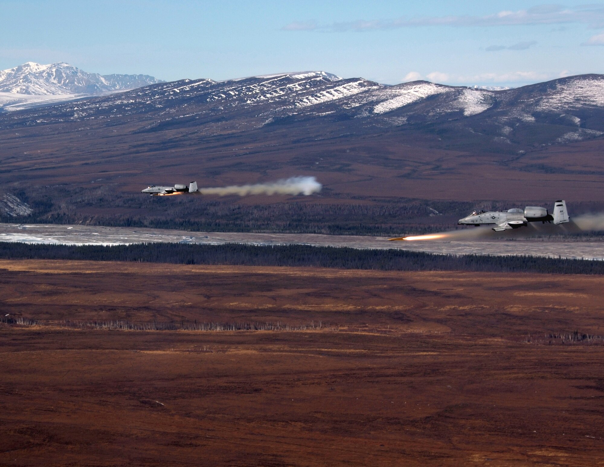 Two A-10 Thunderbolt IIs fire AGM-65 Maverick missiles over the Pacific Alaska Range Complex April 24 during live-fire training. The A-10s are from the 355th Fighter Squadron from Eielson Air Force Base, Alaska. Members from the 355th FS are tasked to provide mission ready A-10s and a search and rescue capability, in Alaska and deployed sites worldwide. (U.S. Air Force photo/Master Sgt. Robert Wieland) 
