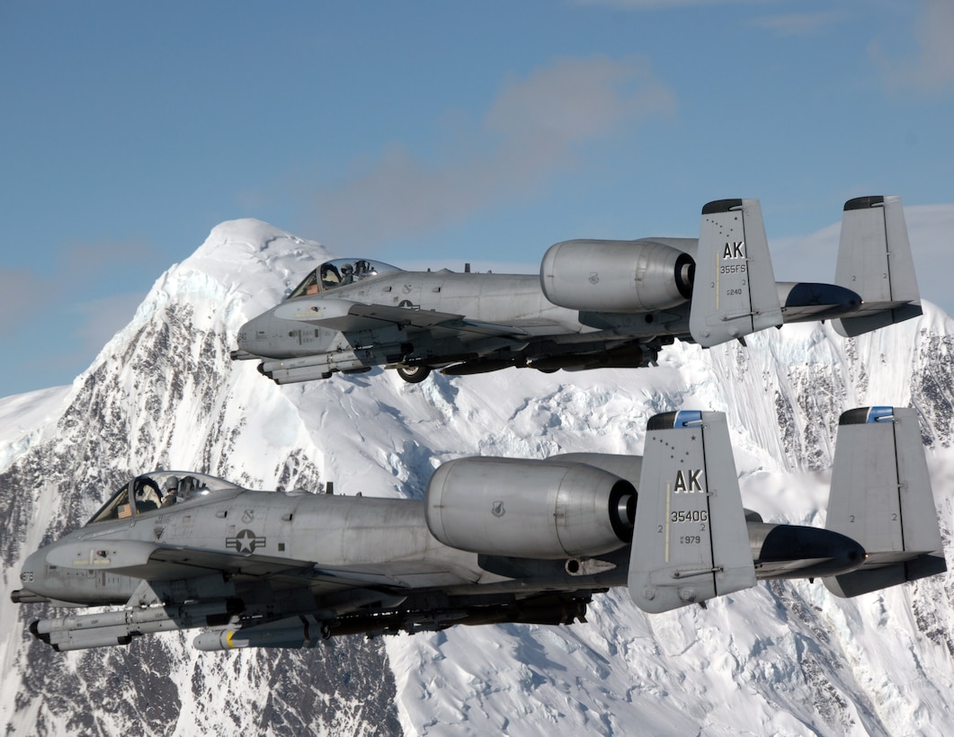 Two A-10 Thunderbolt IIs fly over the Pacific Alaska Range Complex April 24 during live-fire training. The A-10s are from the 355th Fighter Squadron from Eielson Air Force Base, Alaska. Members from the 355th FS are tasked to provide mission ready A-10s and a search and rescue capability, in Alaska and deployed sites worldwide. (U.S. Air Force photo/Master Sgt. Robert Wieland)