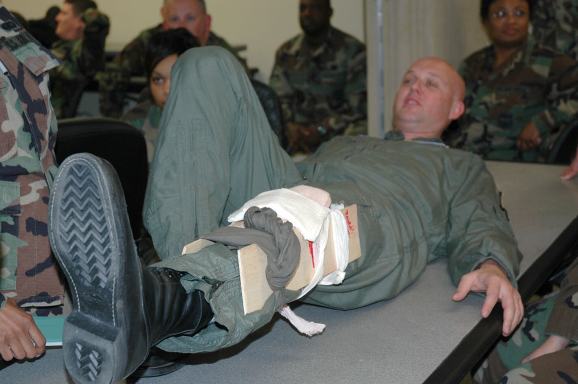 Maj. Ty Piercefield, a pilot with the 53rd Weather Reconnaissance Squadron, volunteered to serve as a "patient" during Self-Aid and Buddy Care class for people from the 403rd Wing. The major's "injury" was an open leg fracture which required students to apply a splint to immobilize the limb.