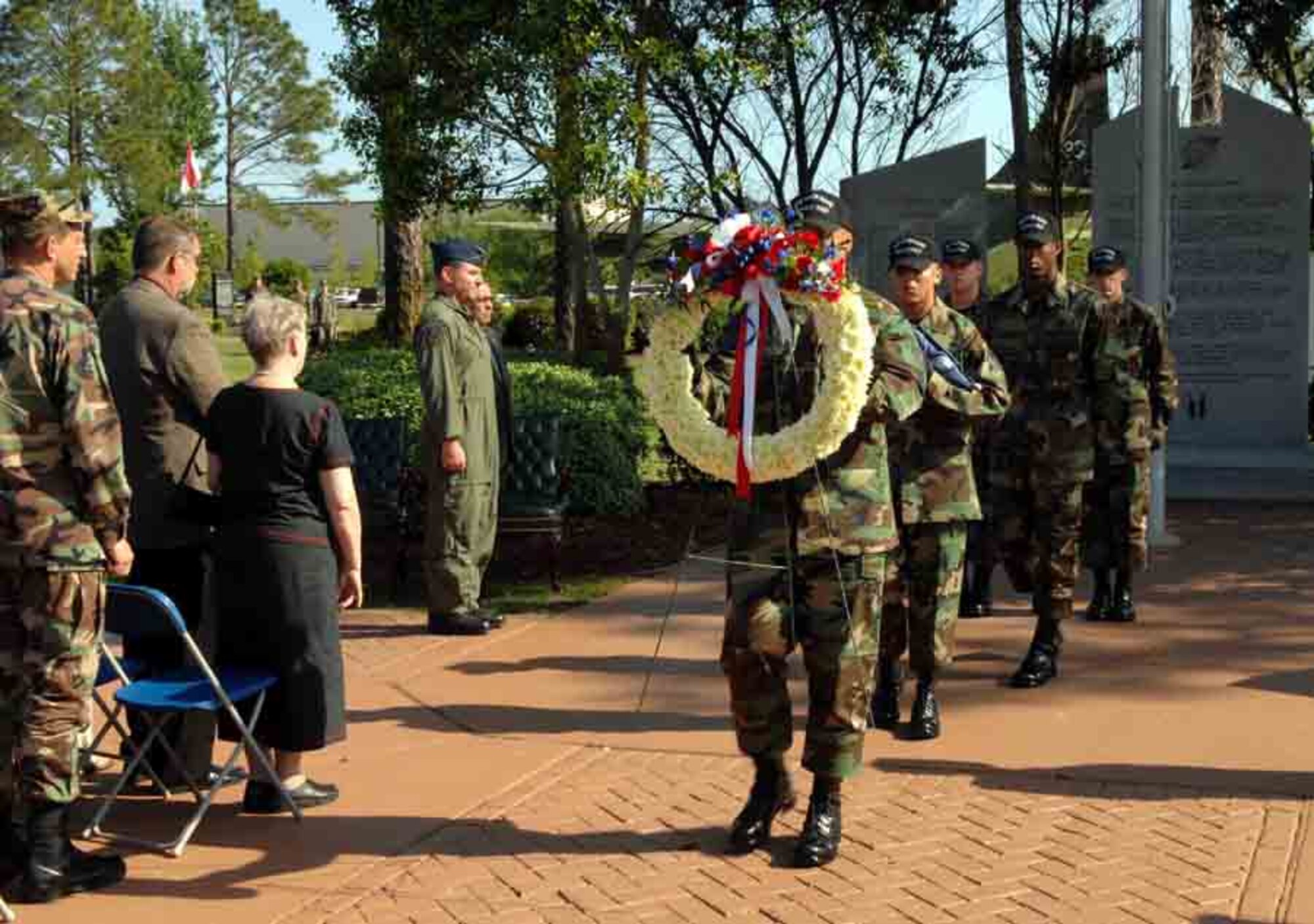A Hurlburt Field Honor Guard member carries a wreath during the Annual Eagle Claw memorial retreat. Five members of the 8th Special Operations Squadron were killed April 24, 1980, in an accident in the desert during an attempt to rescue American citizens held hostage in Iran since November 1979. (U.S. Air Force photo by Senior Airman Stephanie Jacobs)