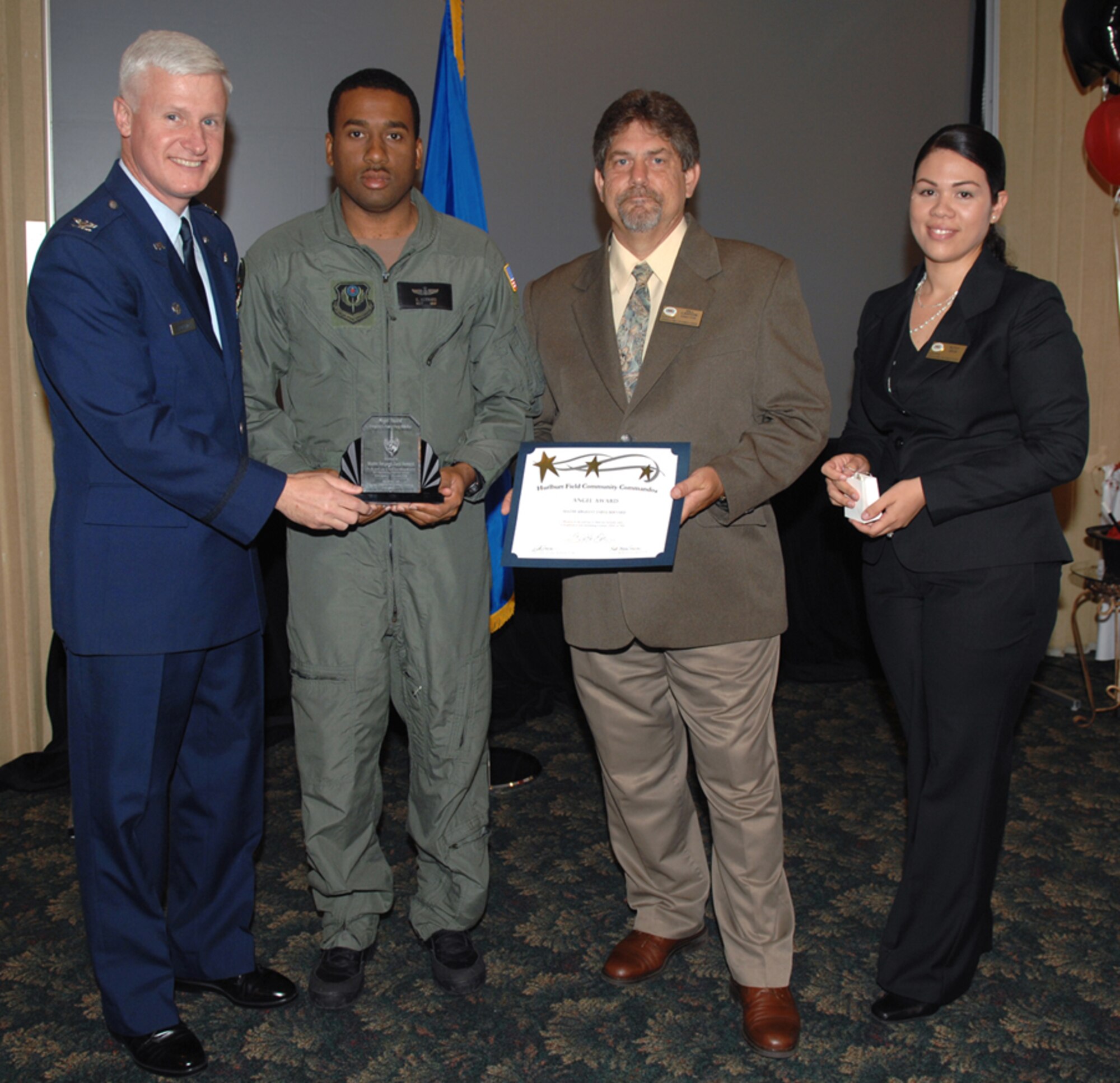 Col. Norman Brozenick Jr., 1st Special Operations Wing commander, presents Master Sgt. Daryl Bernard, 15th Special Operations Squadron, his Angel Award April 10. Bill Lawson and Ruthy Srun, Airman & Family Readiness Center, presented Sergeant Bernard with a certificate. (Courtesy photo)