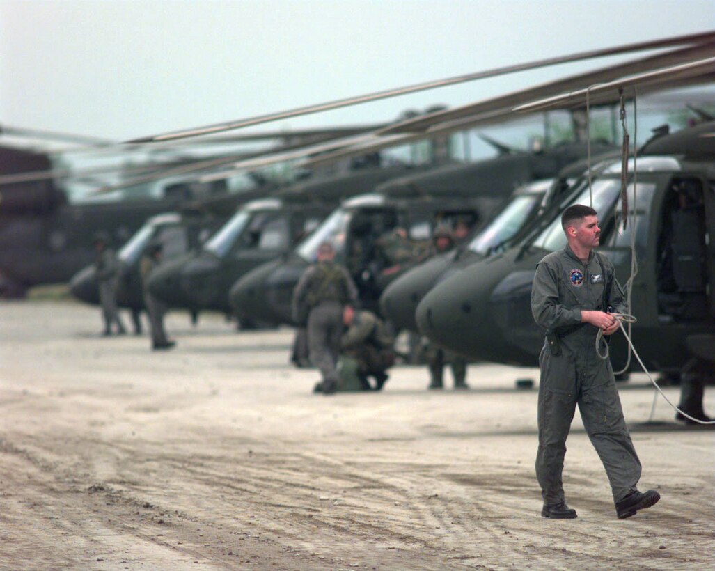 UH-60 Black Hawk support helicopters arrive  at Rinas Airport, Tirana, Albania, in support of NATO  Operation Allied Force. Defense Secretary Donald H.  Rumsfeld uses the 1999 operation as a prime example why  standing joint task force headquarters are needed in the  future. When the 60-day air war over Yugoslavia ended, the  ad hoc headquarters formed to coordinate it had filled only  80 percent of its necessary slots. Photo by Tech. Sgt.  Cesar Rodriguez, USAF.