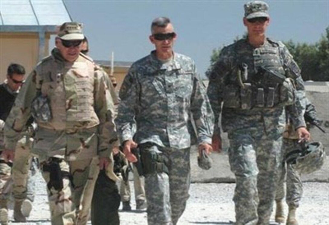 U.S. Navy Adm. William J. Fallon (left), Army Maj. Gen. David Rodriguez (right) and Army Col. John Nicholson walk to a meeting of key Task Force Spartan leaders, April 25, 2007, at Jalalabad Airfield in Afghanistan.