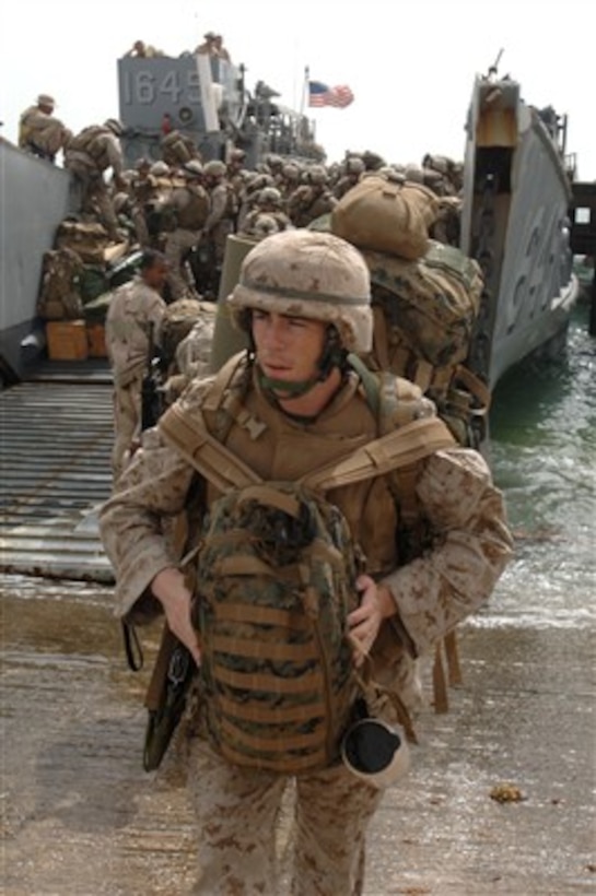 U.S. Marines attached to the 26th Marine Expeditionary Unit disembark a landing craft for an offload of troops and equipment from the USS Bataan (LHD 5) in Southwest Asia on April 20, 2007.  The Bataan Expeditionary Strike Group is operating in the Persian Gulf conducting maritime security operations.  