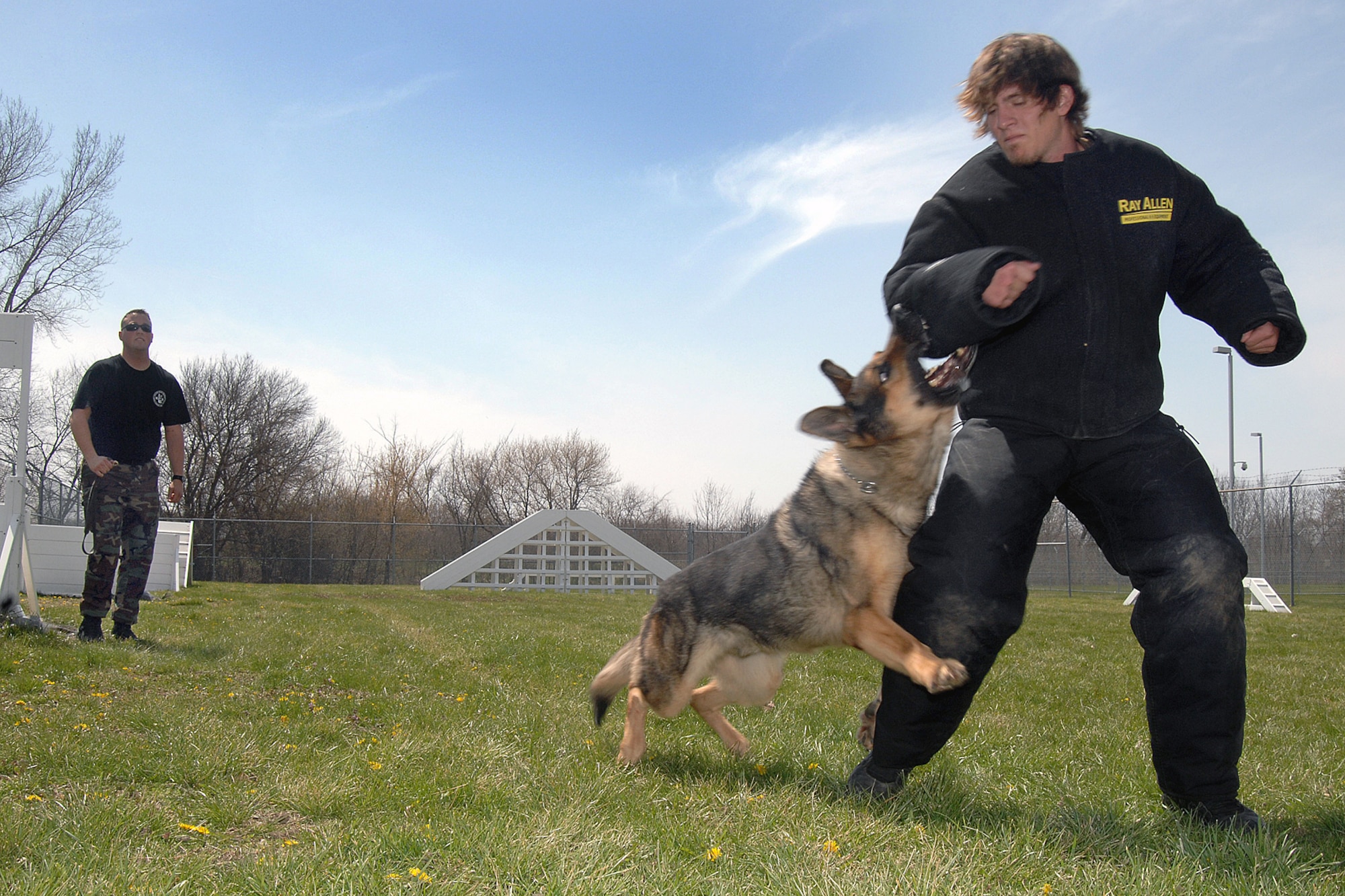 OFFUTT AIR FORCE BASE, Neb. -- Staff Sgt. Bryan Gudmundson, 55th Security Forces Squadron, realeases Norman, a 55th SFS military working dog, to chase down his target, volunteer Cole Tesar, during training April 17. Mr. Tesar is wearing an undergarment bite suit for protection. The Offutt K-9 unit performs regular training to maximize the dogs' effectiveness in the field. (U.S. Air Force Photo by Josh Plueger)