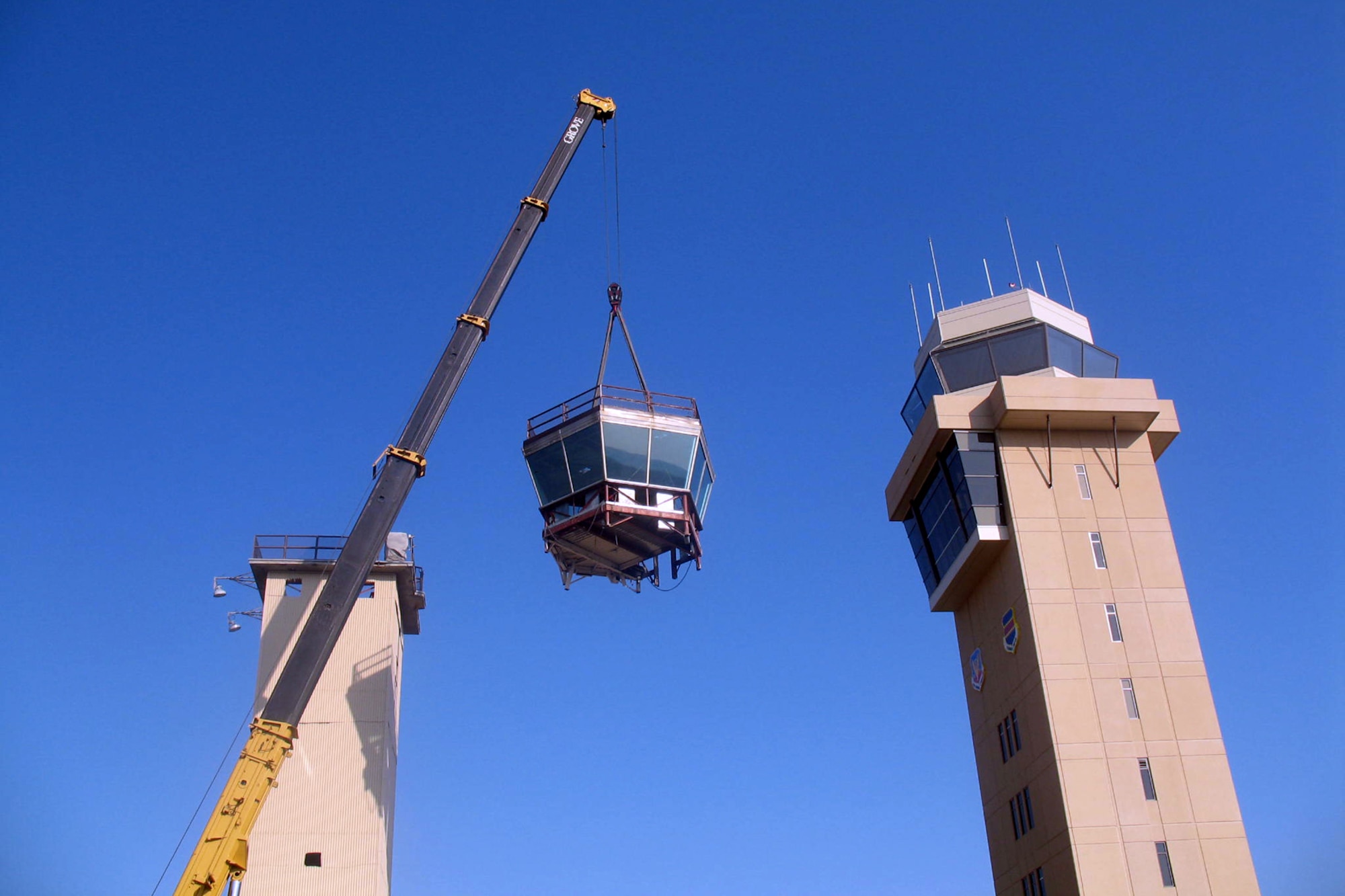 OFFUTT AIR FORCE BASE, Neb. -- A crane lifts the cab off of the old air traffic control tower April 21. The remainder of the old tower was dismantled by early afternoon. A ribbon cutting for the new air traffic control tower is scheduled for 11 a.m. May 9. (U.S. Air Force Photo by Bruce McCauley)