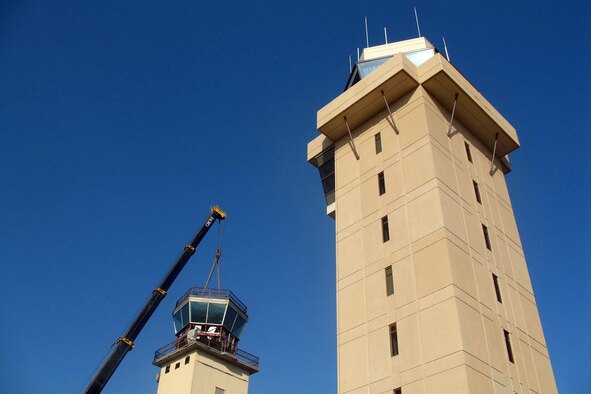 OFFUTT AIR FORCE BASE, Neb. -- A crane lifts the cab off of the old air traffic control tower April 21. The remainder of the old tower was dismantled by early afternoon. A ribbon cutting for the new air traffic control tower is scheduled for 11 a.m. May 9. (U.S. Air Force Photo by Bruce McCauley)