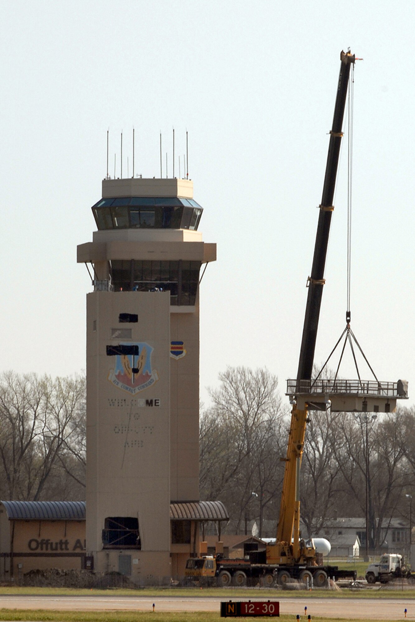 OFFUTT AIR FORCE BASE, Neb. -- A crane prepares to remove a portion of the old air traffic control tower April 21. The remainder of the old tower was dismantled by early afternoon. A ribbon cutting for the new air traffic control tower is scheduled for 11 a.m. May 9. (U.S. Air Force Photo by Josh Plueger)