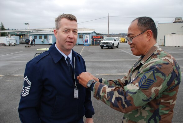SMSgt. Mike Rak gets a final "mike check" of the sound system before filming with MSgt. John Nonog in Washington state.  They filmed the final inspection of a C-40C just before it flew to Illinois to the 932nd Airlift Wing.