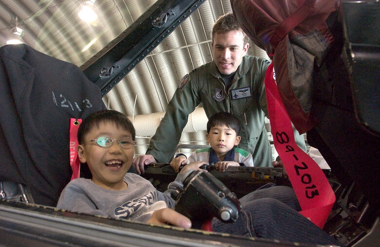 KUNSAN AIR BASE, Republic of Korea  April 27, 2007 -- Capt. Aaron Jelinek, 35th Fighter Squadron fighter pilot, shows an F-16 cockpit to children from a Gunsan City orphanage during their visit here April 27. The 35th FS hosted the orphanage as part of the 8th Fighter Wing's Good Neighbor Program commitment to supporting the community. The 35th, known as the "Pantons," is one of two F-16 Fighting Falcon squadrons assigned to the 8th Fighter Wing here. (U.S. Air Force photo/Senior Airman Barry Loo.)
