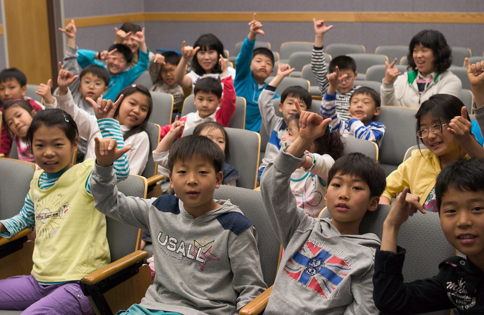 KUNSAN AIR BASE, Republic of Korea  April 27, 2007 -- Children from a local Gunsan City orphanage "push it up" during their visit to the 35th Fighter Squadron here April 27. The "push it up" hand gesture is a traditional way of recognizing other members of the squadron, to include the children who were honored guests during their visit. The squadron hosted the visit as part of the 8th Fighter Wing's Good Neighbor Program commitment to supporting the local community. The 35th, known as the "Pantons," is one of two F-16 Fighting Falcon squadrons assigned to the 8th FW here. (U.S. Air Force photo/Senior Airman Barry Loo.)
