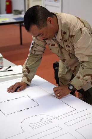 AL ASAD, Iraq - Air Force Maj. Steve Sugiyama, the Antiterrorism Force Protection officer for the International Zone, draws out his vulnerability assessment for the Level II ATFP class held aboard Al Asad, April 29. The class taught ATFP officers how to ensure that the service members in their units remained safe during their deployment.