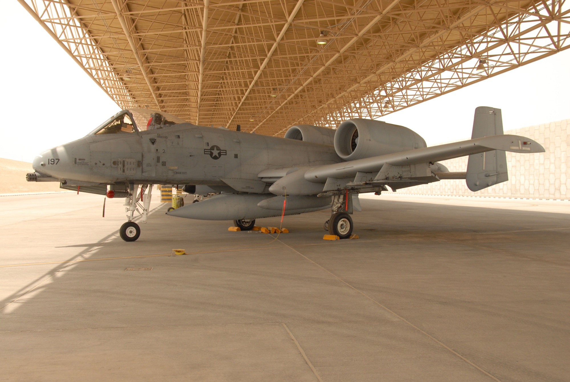 U.S. Air Force A-10 Thunderbolt IIs await a mission at an airbase in Southwest Asia in support of operations in Iraq. The A-10 is a single-seat, twin-engine aircraft designed to provide close air support of ground forces by attacking armored vehicles and other ground targets. As a secondary mission, it provides airborne forward air control guiding other aircraft against ground targets. It is the first U.S. Air Force aircraft designed exclusively for close air support. (U.S. Air Force photo)