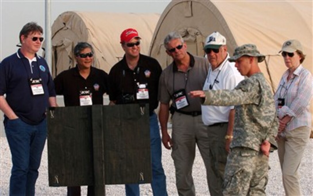 Joint Civilian Orientation Conference participants tour the 3rd Battalion, 43rd Air Defense Artillery Patriot Battery at an air base in Southwest Asia, April 29, 2007. An Army soldier answers questions about the Battery's huge antenna array.