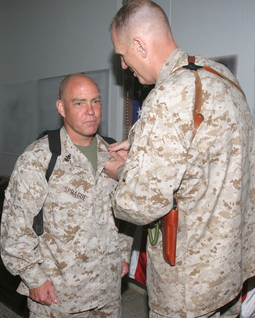 AL ASAD, Iraq- Brig. Gen. Timothy Hanifen, commanding officer 2nd Marine Aircraft Wing (Forward), pins chevrons on Master Chief Petty Officer Douglas Sprague, command master chief petty officer of 2nd MAW (Fwd.), during a promotion ceremony, April 30. Sprague was frocked to his current rank.