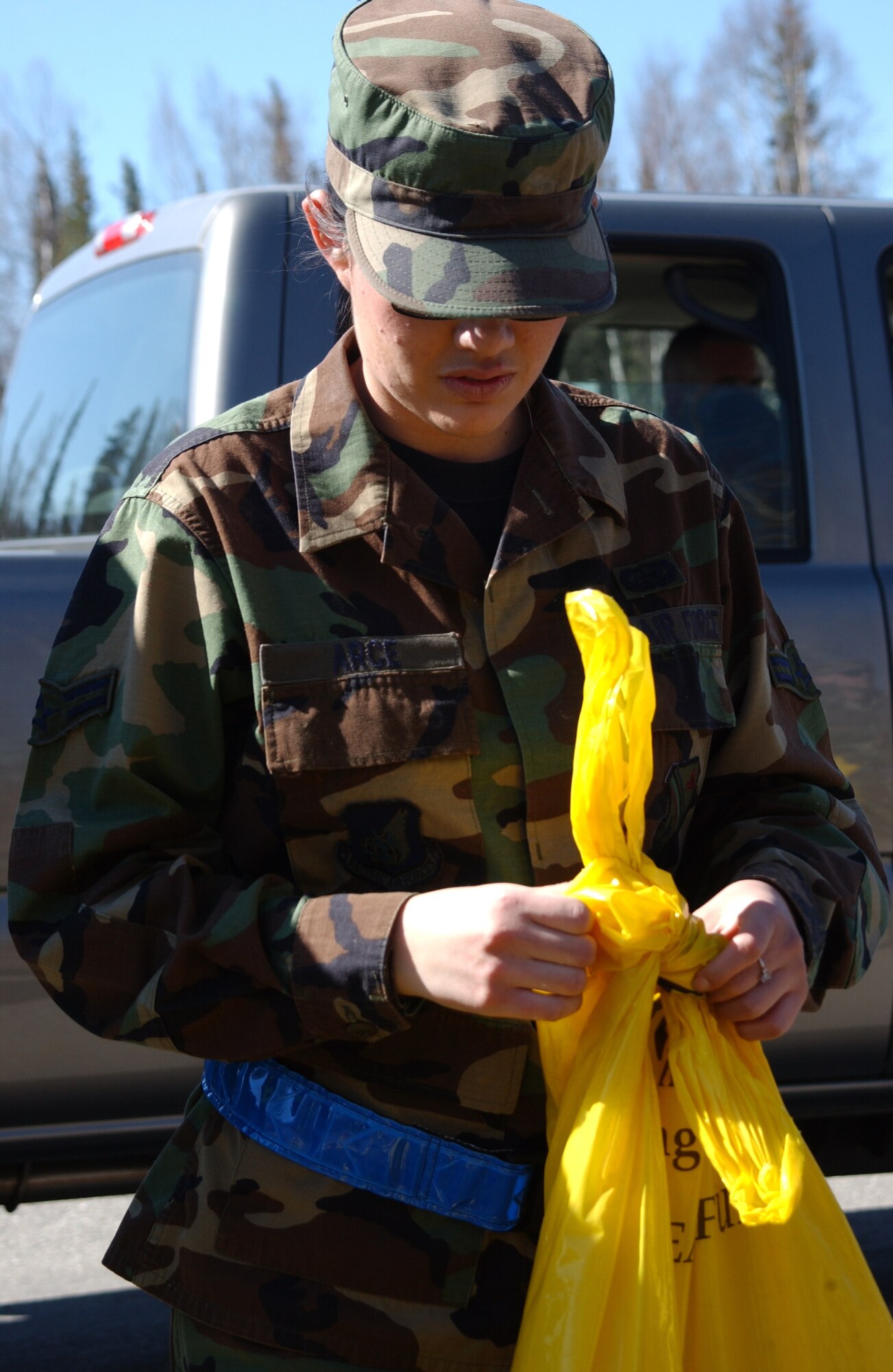 EIELSON AIR FORCE BASE, Alaska -- Airman 1st Class Claudia Arce, 354th Communications Squadron, finishes picking up garbage on the Richardson highway on April 26. The 354th Communications Squadron participates in a base wide beautification project every break up season. (U.S. Air Force Photo by Airman 1st Class Jonathan Snyder) 
