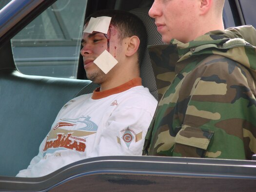 Airman 1st Class Joel Reyes-Rodriguez, 90th Missile Security Forces Squadron, is watched over by Airman 1st Class Aaron Dufour, 90th Logistics Readiness Squadron, after receiving 'injuries' during the tornado scenario exercise April 16. The exercise showed how Warren would respond to a natural disaster using the Air Force Incident Management System (Courtesy photo).