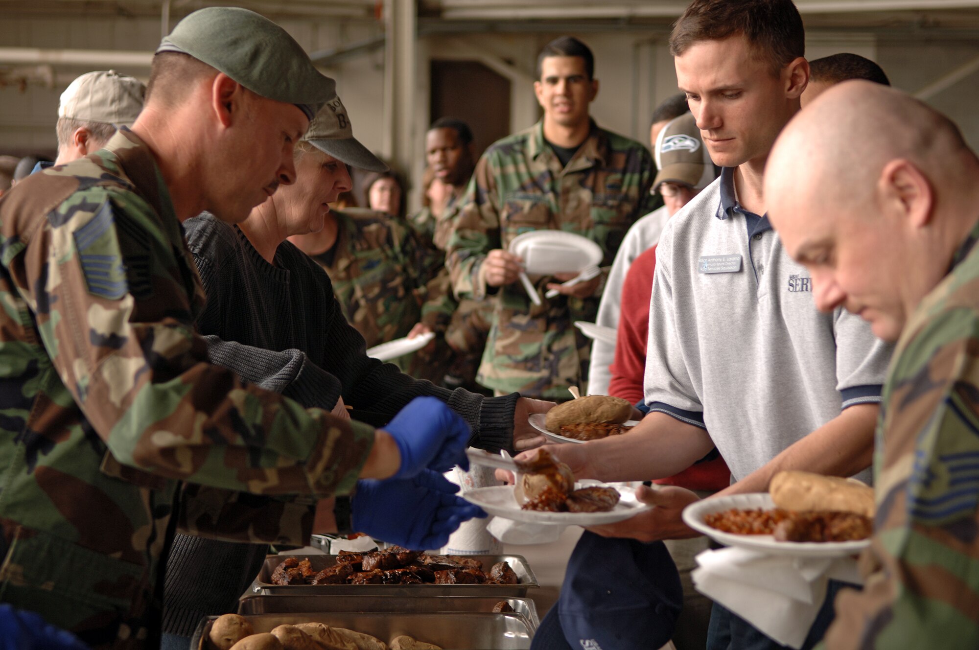 FAIRCHILD AIR FORCE BASE, Wash. – Chief Master Sgt. William Welch, 336th Training Group, and Chief Master Sgt. Michelle Bailey, 92nd Maintenance Group, serve food to Fairchild’s Airmen during the Chief’s Steakout in Hanger 2 here April 25. (U.S. Air Force photo/Airman 1st Class Joshua Chapman)