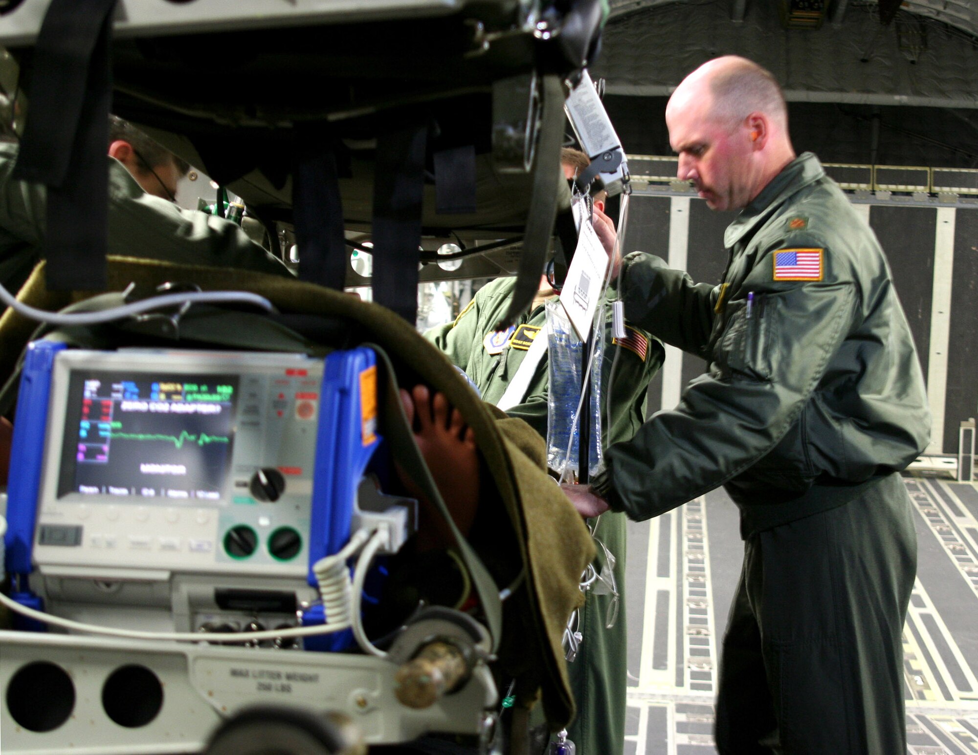 Maj. (Dr.) Joseph Lawlor monitors a simulated patient onboard a C-17 Globemaster III. Five squadrons and about 80 medical personnel from California, Florida, Maryland and Georgia participated in the Air Force Reserve Aeromedical Evacuation Jamboree held April 28 and 29 at Wright-Patterson Air Force Base, Ohio. Major Lawlor is a flight surgeon with the 445th Aeromedical Staging Squadron, and is assigned to a Critical Care Air Transport Team or CCATT that closely monitors seriously ill or wounded patients. (U.S. Air Force photo/Maj. Ted Theopolos)