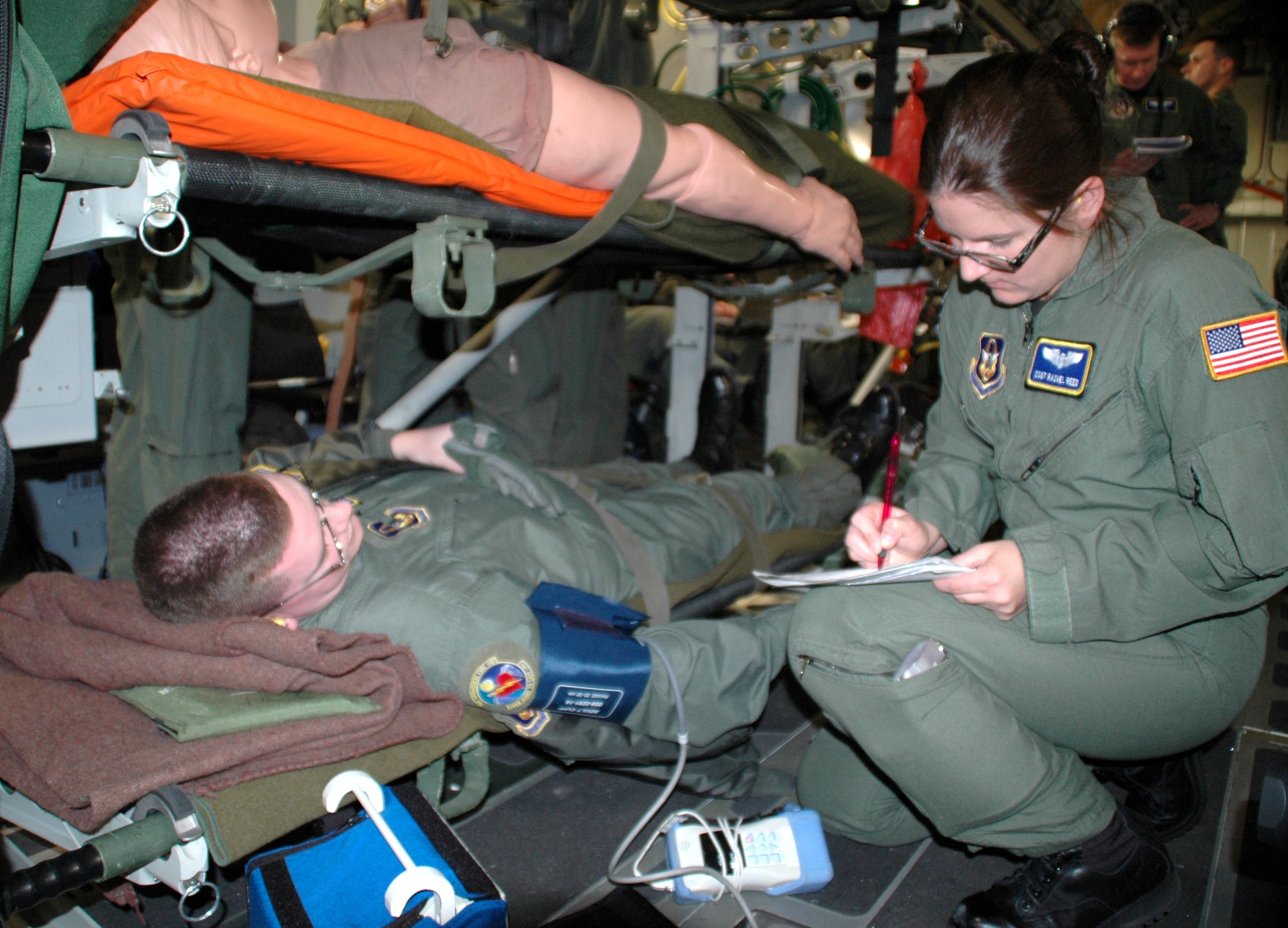Aeromedical technician Staff Sgt. Rachel Reed checks on a simulated patient, Tech. Sgt. Joseph Drake, in flight on a C-17 Globemaster III while the medical crew is put to the test with a variety of scenarios by medical flight instructors. Five squadrons and about 80 medical personnel from California, Florida, Maryland and Georgia participated in the Air Force Reserve Aeromedical Evacuation Jamboree held April 28 and 29 at Wright-Patterson Air Force Base, Ohio. Both sergeants are from the 445th Aeromedical Evacuation Squadron. (U.S. Air Force photo/Tech. Sgt. Charlie Miller)