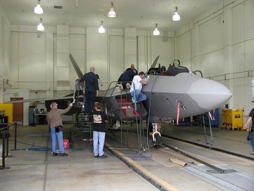 Cutline: Mechanics from the 309th Aircraft Maintenance Group F-22 Division install the Night Air-to-Air Refueling modification on an F-22. Courtesy photo
