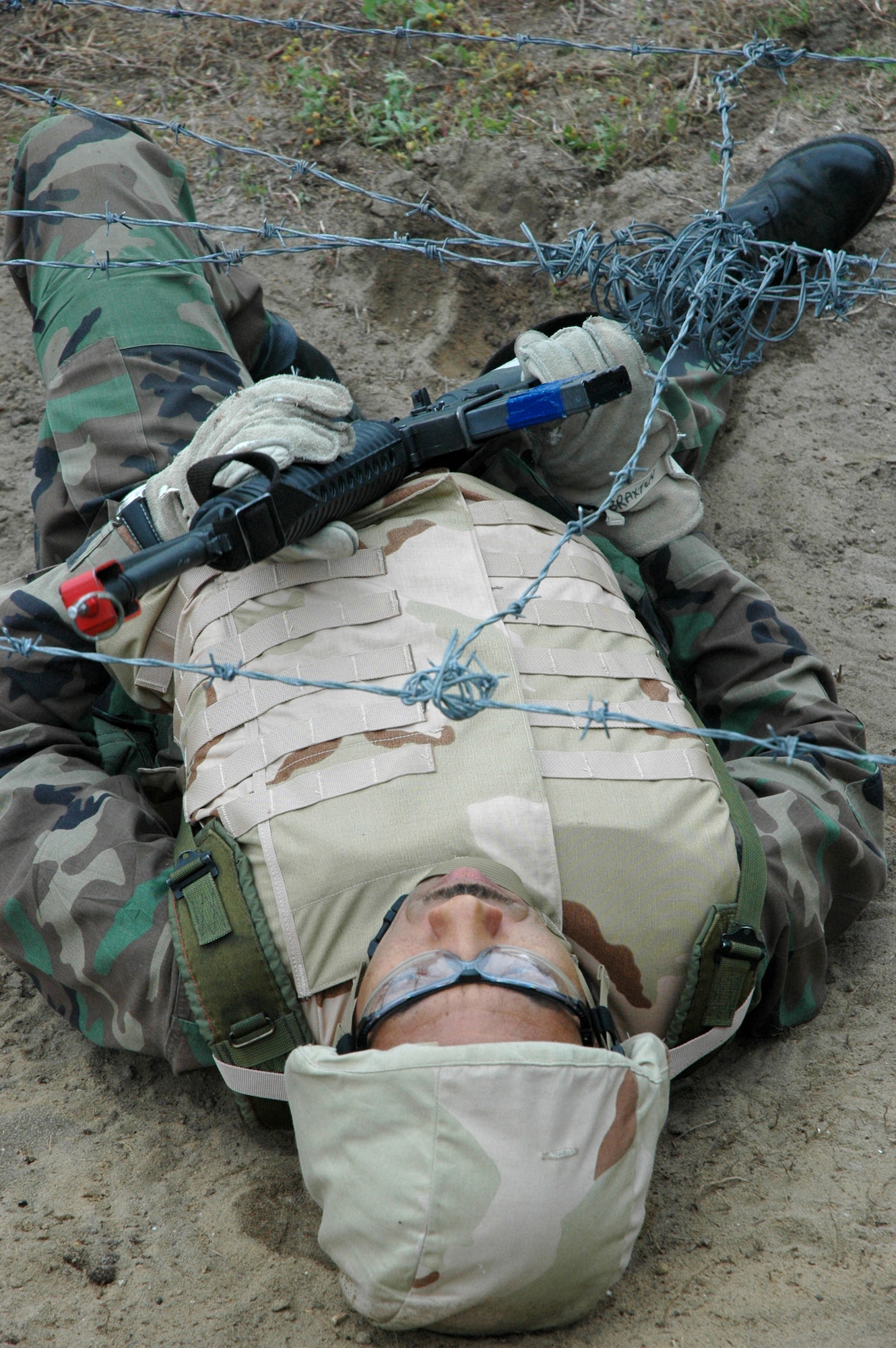 EGLIN AIR FORCE BASE, Fla. - Capt. Archer Braxton, 96th Surgical Operations Squadron, negotiates a barbed wire obstacle while tackling a simulated battlefield during Expeditionary Combat Skills training April 18. The exercise culminated three days of combat skills training. (U.S. Air Force photo by Staff Sgt. LuCelia Ball)