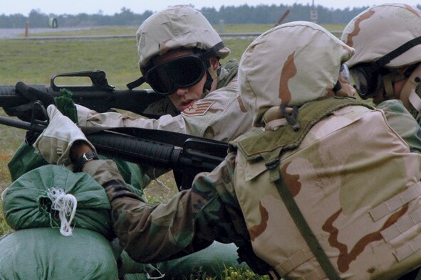EGLIN AIR FORCE BASE, Fla. - Staff Sgt. Robert Poole, 96th Surgical Operations Squadron, confers with a "battle buddy" while tackling a simulated battlefield during Expeditionary Combat Skills training April 18. The exercise culminated three days of combat skills training. (U.S. Air Force photo by Staff Sgt. LuCelia Ball)