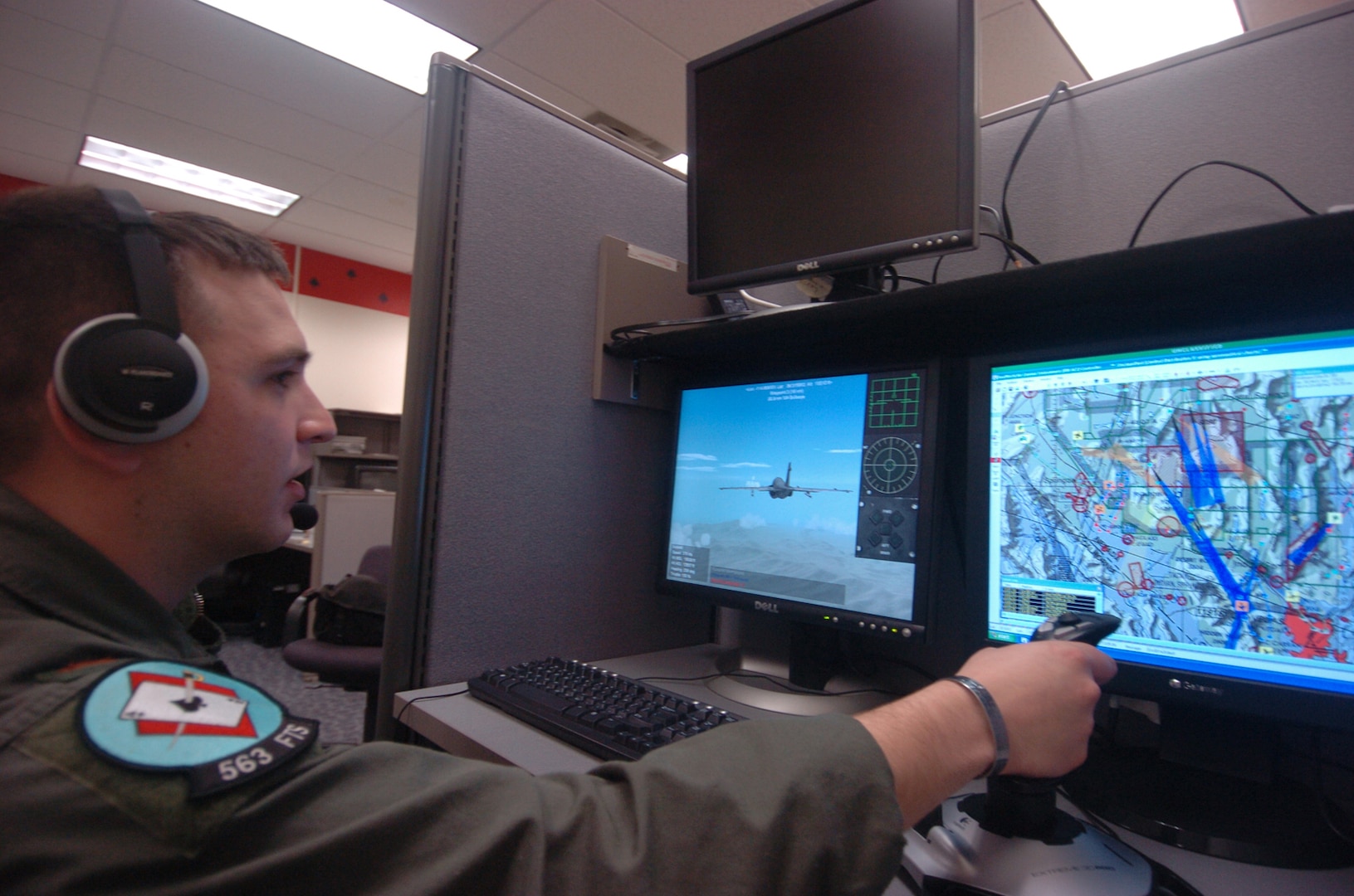 2nd Lt. Travis Ryan, 563rd Flying Training Squadron Electonic Warfare Officer student, demonstrates the RealWorld Air Combat Environment simulator, which allows up to ten students to fly different platforms in the same battle space. RealWorld is being developed for use in 563rd FTS curriculum. (U.S. Air Force photo by Rich McFadden)