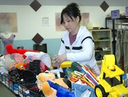 MINOT AIR FORCE BASE, N.D. -- Michelle Gonyea helps sort toys and other items at the Airman's Attic here April 27. The Minot Air Force Base Airman’s Attic is a volunteer-run base organization that exists to lend a helping hand to all Airmen in need. The attic works similarly to commercial donation organizations, only there’s no charge to customers. (U.S. Air Force photo by Airman 1st Class Wesley Wright)