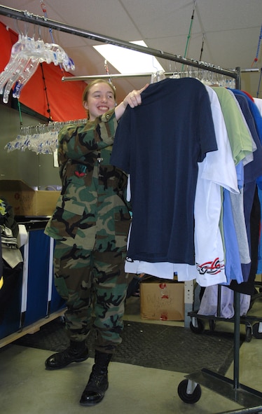 MINOT AIR FORCE BASE, N.D. -- Airman 1st Class Stephanie Campbell, 5th Communications Squadron, helps stock clothing at the Airman's Attic here April 27. The Minot Air Force Base Airman’s Attic is a volunteer-run base organization that exists to lend a helping hand to all Airmen in need. For more information or to volunteer, call 723-1818. (U.S. Air Force photo by Airman 1st Class Wesley Wright)