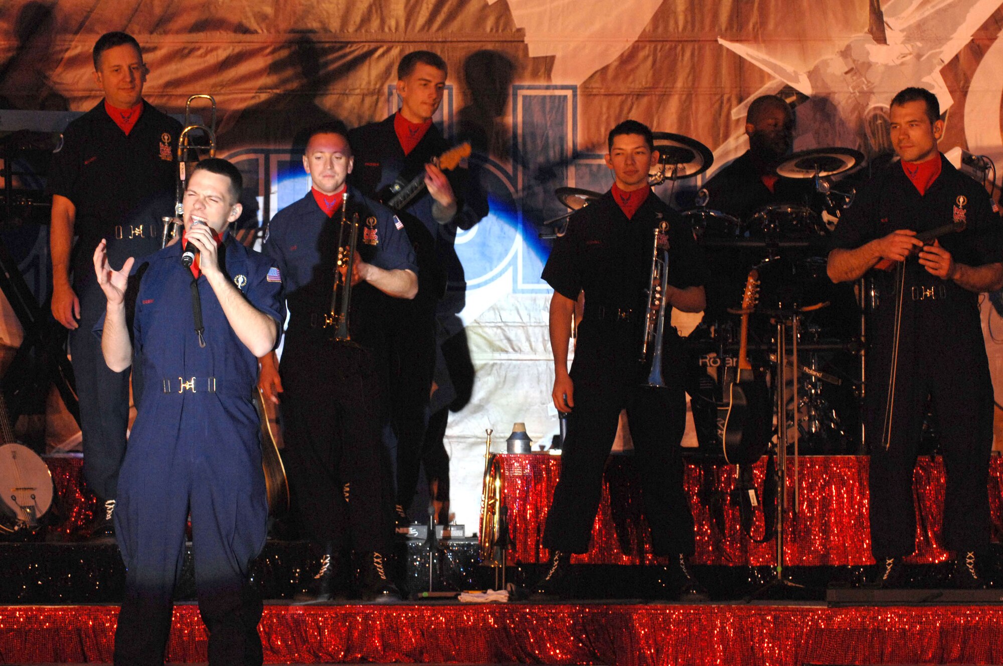 A Tops in Blue Airmen sings to Airmen and Soldiers April 26 at Kirkuk Air Base, Iraq. The 30-member group's goal is to enhance mission productivity for Air Force members around the world. Tops in Blue showcases music, dance and comedy -- all performed by active-duty Airmen who perform 90 minutes of non-stop live entertainment. (U.S. Air Force photo/Senior Airman Bradley A. Lail) 
