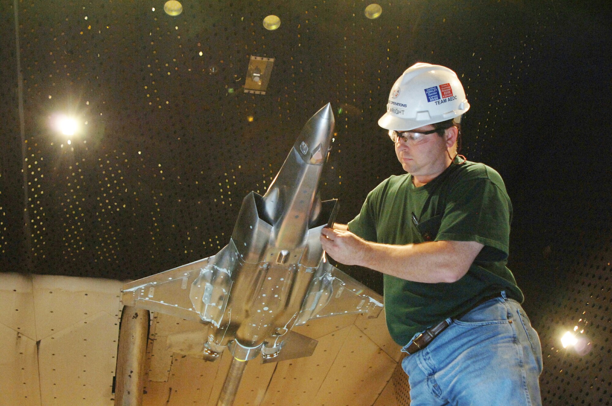 Tim Wright, an Aerospace Testing Alliance craftsman at Arnold Engineering Development Center at Arnold Air Force Base, Tenn., examines the Short Take-off and Landing F-35 model in AEDC’s 16-foot transonic wind tunnel. The information from this testing, the final entry in a recent series of tests, will go into a large database to refine and validate the aircraft designs for flight testing and ultimately, production of the CTOL and STOVL F-35 variants.