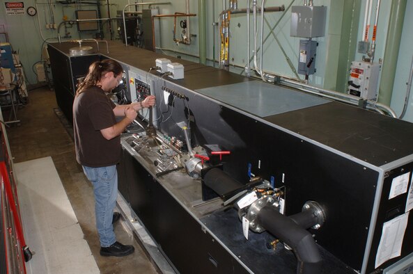 Brian Hale, an ATA instrument technician at AEDC’s Precision Measurement Evaluation Laboratory, installs a flow meter onto the flow bench for calibrating.